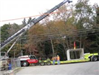 Cement Block on Trailer Being Strapped to Crane
