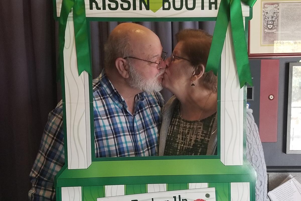 Couple Kissing in the Kissing Booth