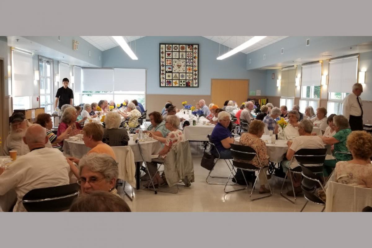 Room Full of Tables and People Eating