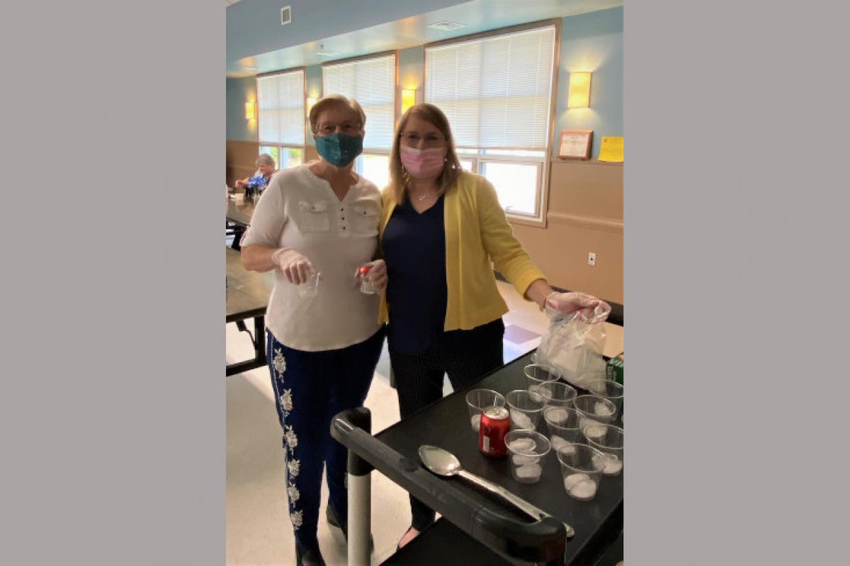 Staff Members Helping Serve Guests