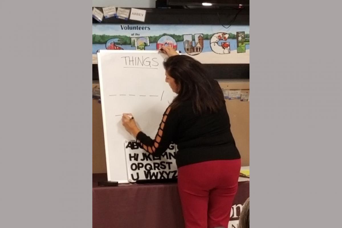 Person Writing on White Board