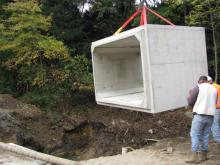 Large Cement Block Being Moved by Hoist