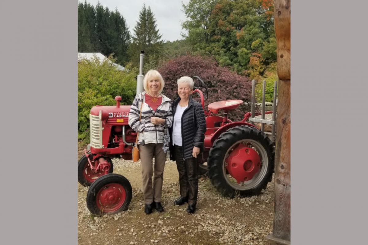 Two Women in Front of a Small Tractor