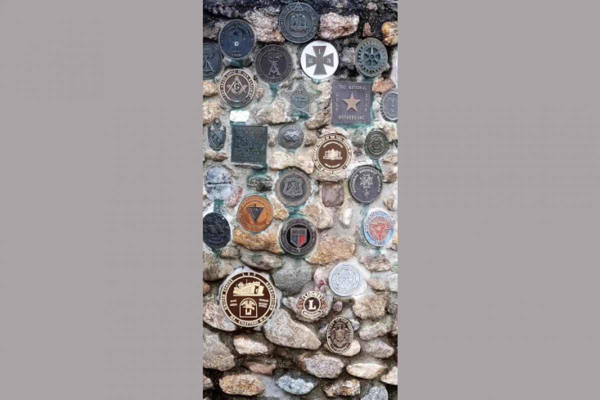 Metal Pins and Badges in Stone Memorial