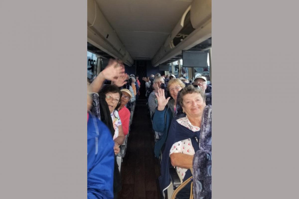 People Waving on Bus