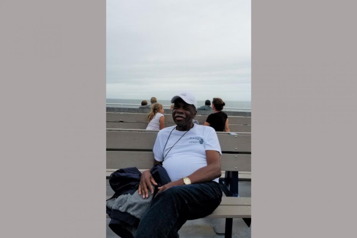 Person Sitting on Bench by the Water