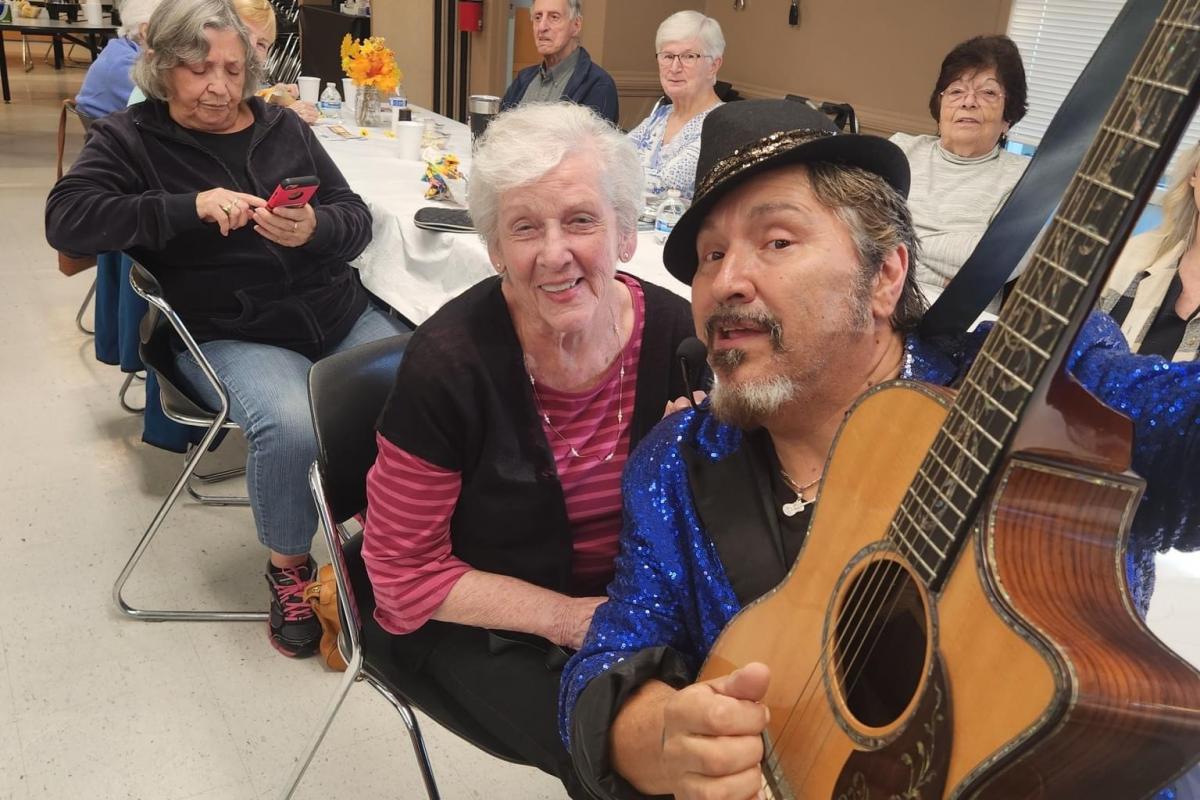 Singer with Guitar Posing with Attendee