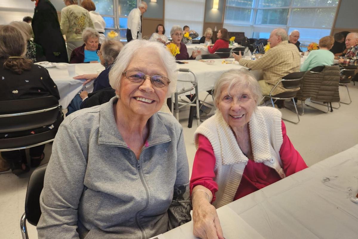 Two Women Smiling at Table