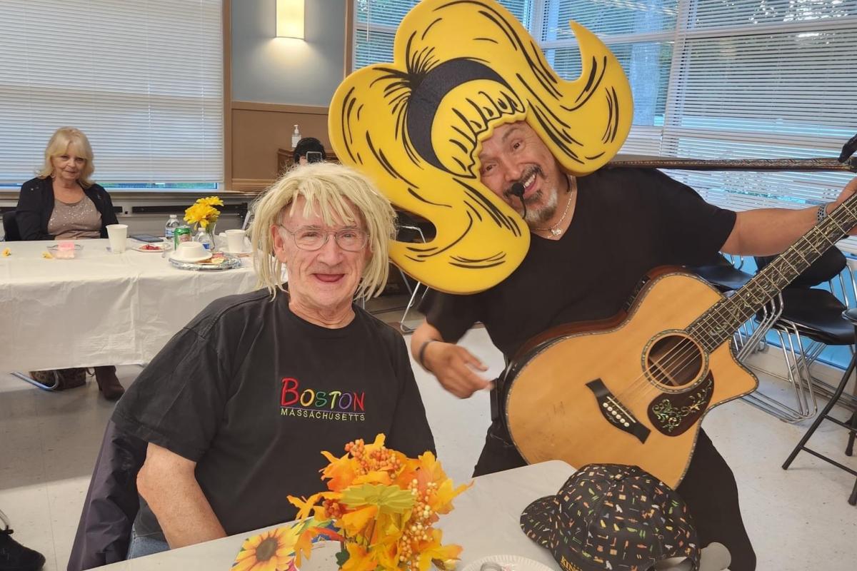 Man Playing Guitar and Singing for Attendees