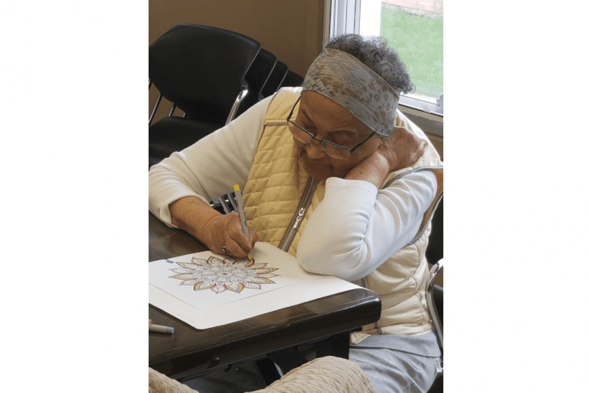 Woman Using Markers to Color Black and White Picture