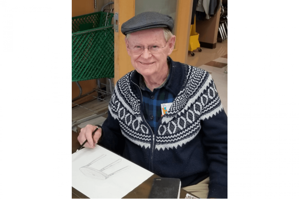 Man Smiling While Drawing