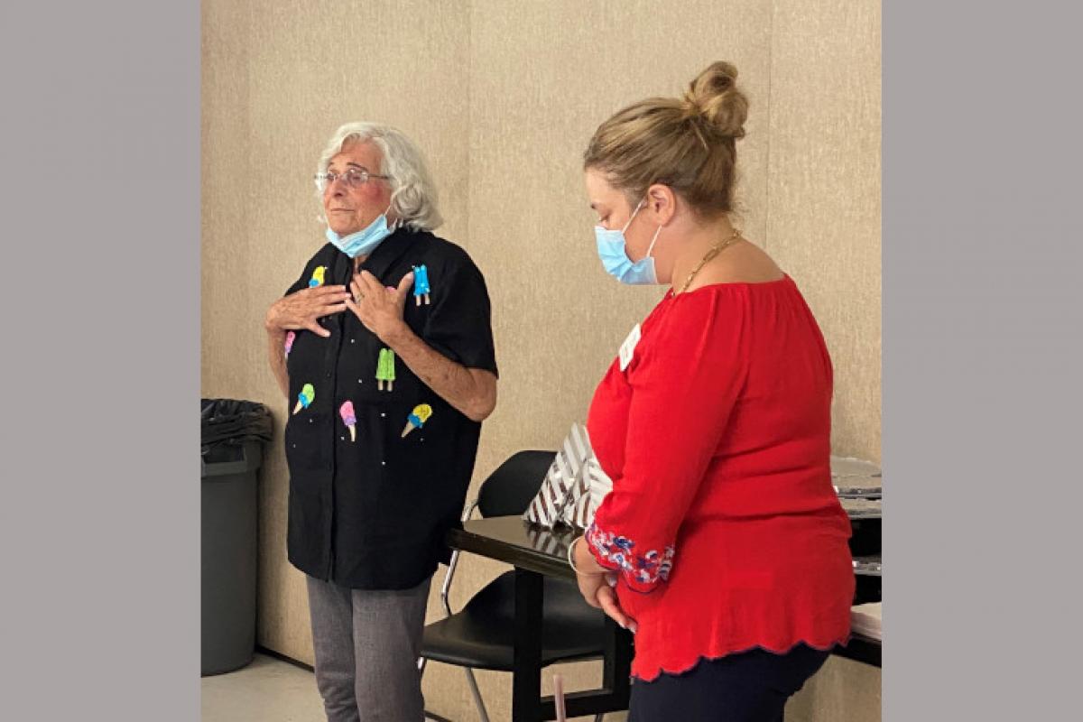 Woman Addressing Room of People