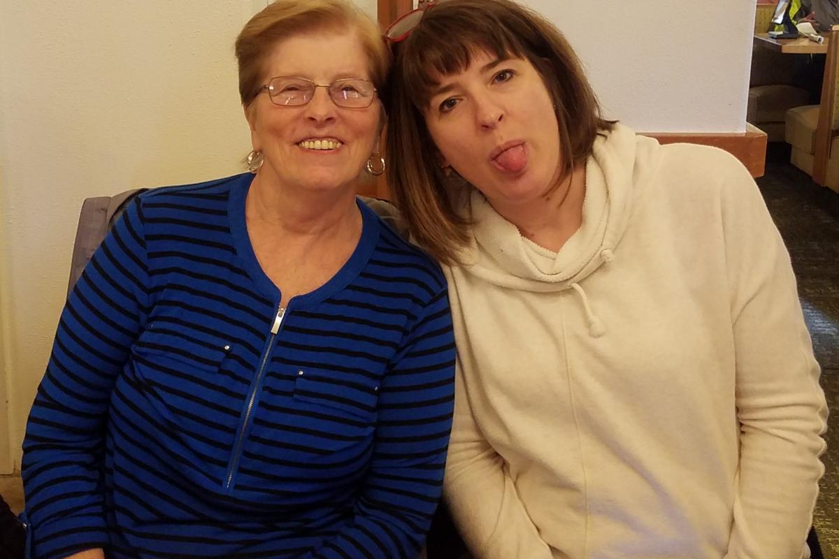 Two Women, One Sticking Tongue Out