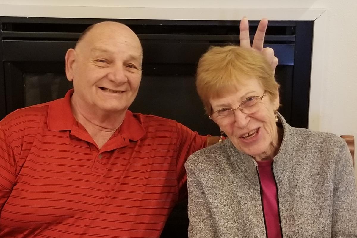 Man Giving Woman Bunny Ears for Photo