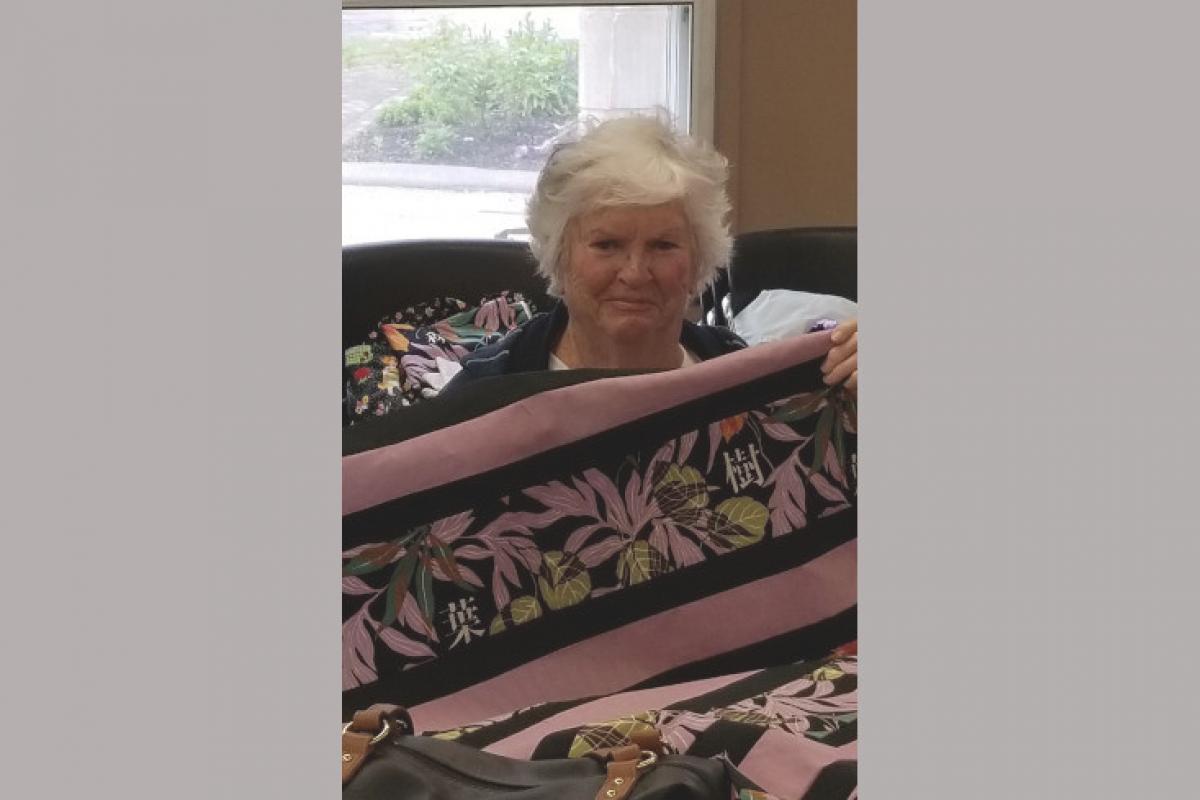 Woman Holding Up Quilt