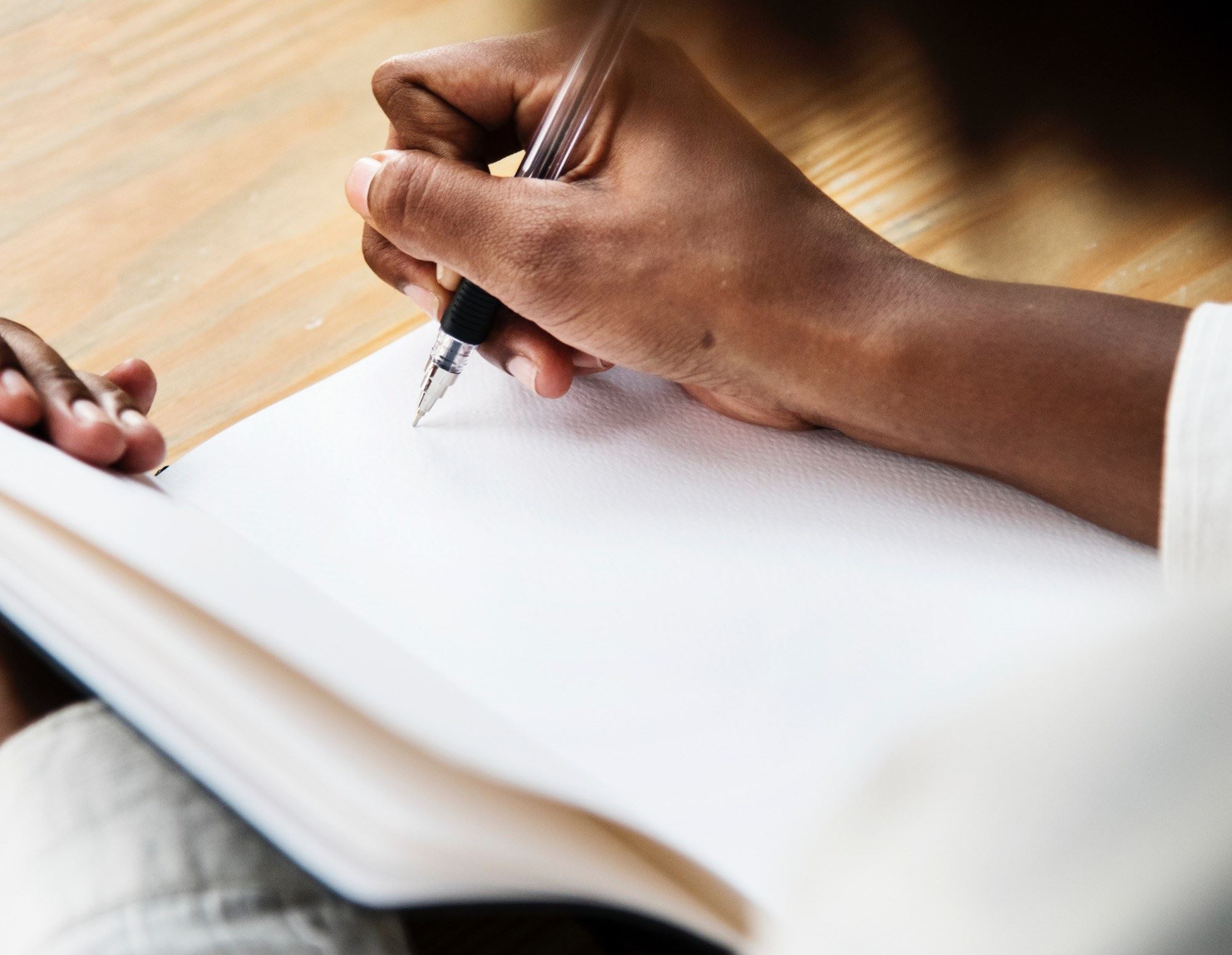Side profile of a woman writing in a journal